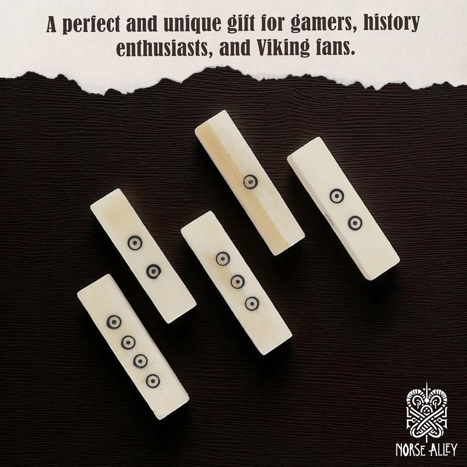 Five handcrafted Viking Bone Dice, ivory-colored with black dots, are arranged on a dark surface. “A perfect and unique gift for gamers, history enthusiasts, and Viking fans.” Norse Alley logo appears bottom right. Set includes 5 dice.