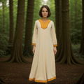 A woman stands in a serene forest, wearing the Nordic Runeweave Viking Dress—an elegant, cream-colored gown with orange-trimmed collar, cuffs, and hem that highlights fine Norse craftsmanship amidst tall trees and lush greenery.