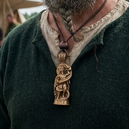 A person with a braided beard wears a green tunic and the Thor Serpent Pendant – The Thunder God, an intricately carved Norse-style pendant on a leather cord, evoking classic Viking mythology jewelry.
