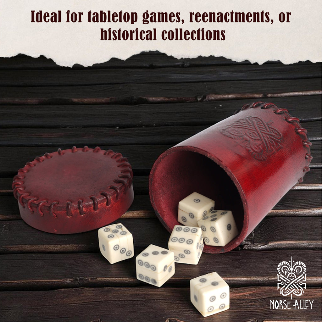 A Bone Dice – Set of 6 Viking Style 6-Sided Dice tumbles from a red leather Norse-themed cup onto a dark wood table. Text above says, Ideal for tabletop games, reenactments, or collections. Norse Alley logo appears bottom right.