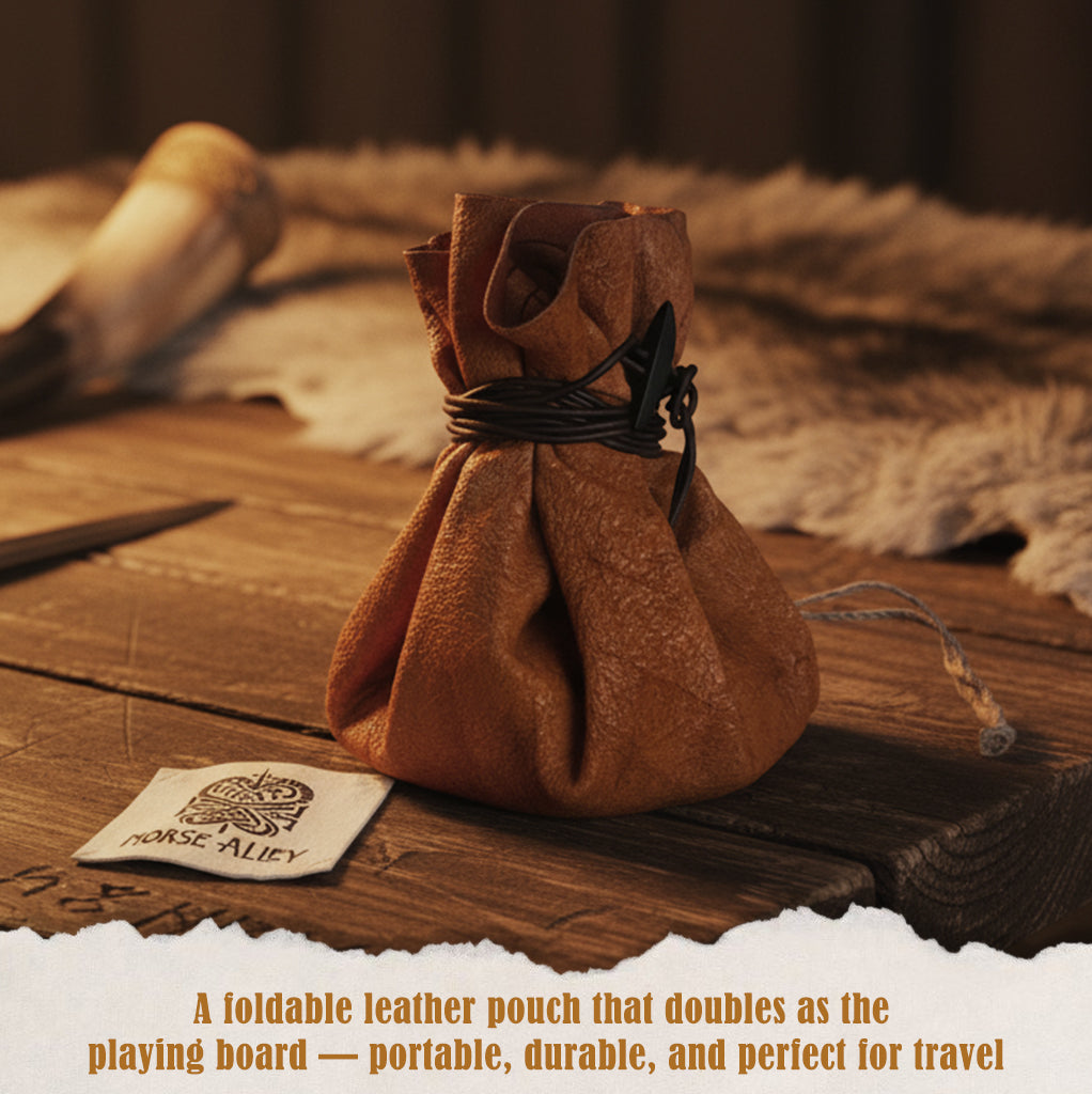 A brown foldable leather pouch tied with a black cord sits next to a cloth label reading Norse Alley. This is the Handcrafted Viking Hnefatafl Set, which doubles as a portable pouch and playing board for the ancient game.