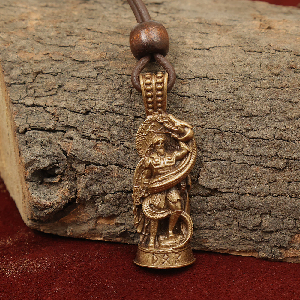 The Thor Serpent Pendant – The Thunder God features a brass warrior with shield and serpent, hanging from a leather cord with a wooden bead—an eye-catching tribute to Norse mythology.
