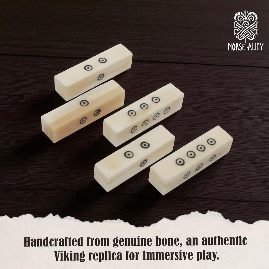 The Viking Bone Dice Set of 5 features handcrafted rectangular dice with black dot markings, displayed on a dark wooden surface. Authentic medieval gaming accessories by Norse Alley, perfect for immersive gameplay.