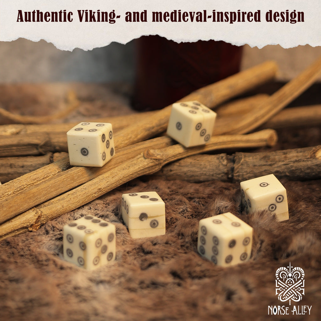 Six handcrafted, ivory-hued bone dice with black dots lie on textured fur among wooden sticks. Text above says "Authentic Viking- and medieval-inspired design," with the Norse-Alley logo at bottom right. Product: Bone Dice – Set of 6 Viking Style 6-Sided Dice.