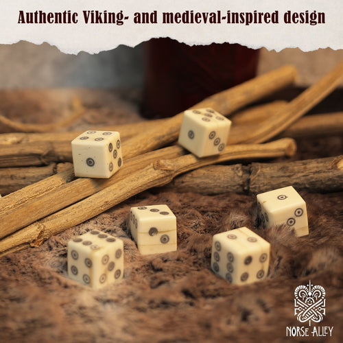 Six handcrafted, ivory-hued bone dice with black dots lie on textured fur among wooden sticks. Text above says "Authentic Viking- and medieval-inspired design," with the Norse-Alley logo at bottom right. Product: Bone Dice – Set of 6 Viking Style 6-Sided Dice.